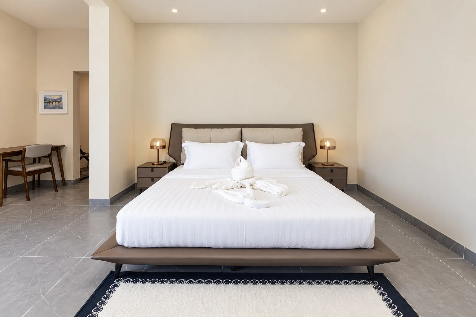 One-Bedroom Apartment — bedroom with large double bed and patterned rug