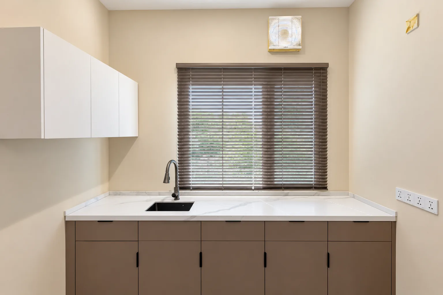 One-Bedroom Apartment — kitchen counter with sink and wall cabinets